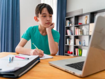 Teenage boy having online school class at home Teenage boy having online school class at home